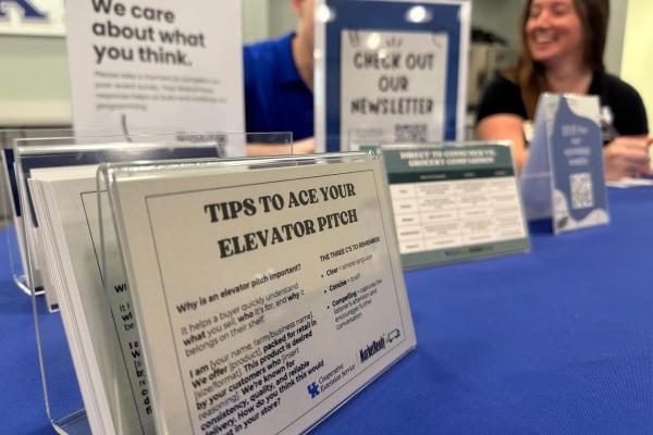 Two people sitting behind a table with a resource tabling display