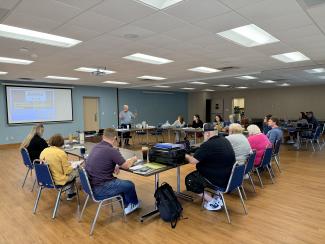 a group of people listening to a presentation