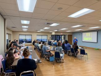 a group of individuals listening to a presentation
