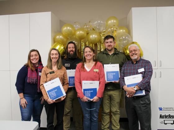 Purdue Extension trainees, along with Savannah Columbia and Dr. Timothy Woods are pictured with MarketReady Producer Training binders